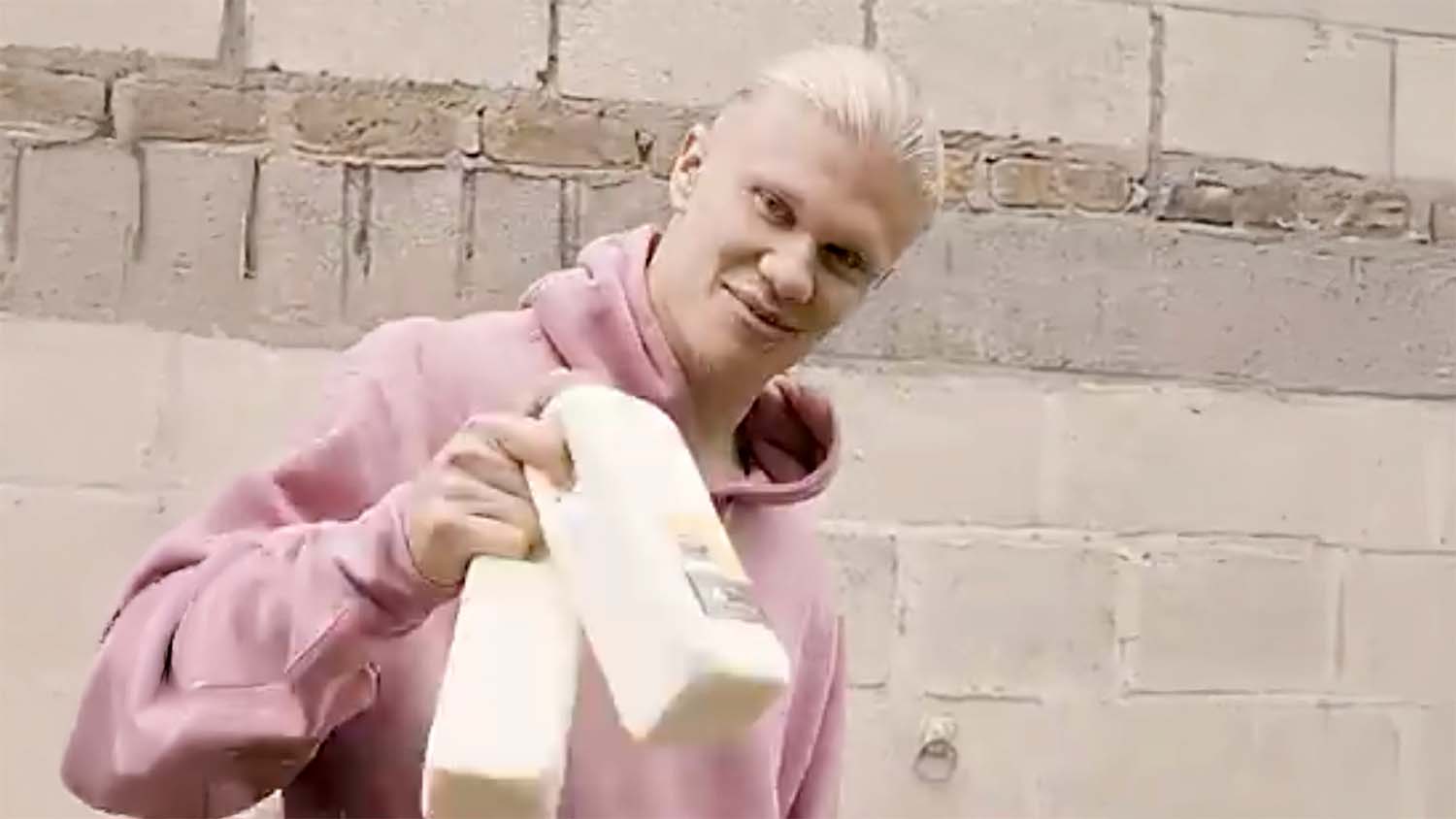 Erling Haaland holding a carton of raw milk from Greenoaks Farm in a still from his October 2025 YouTube video