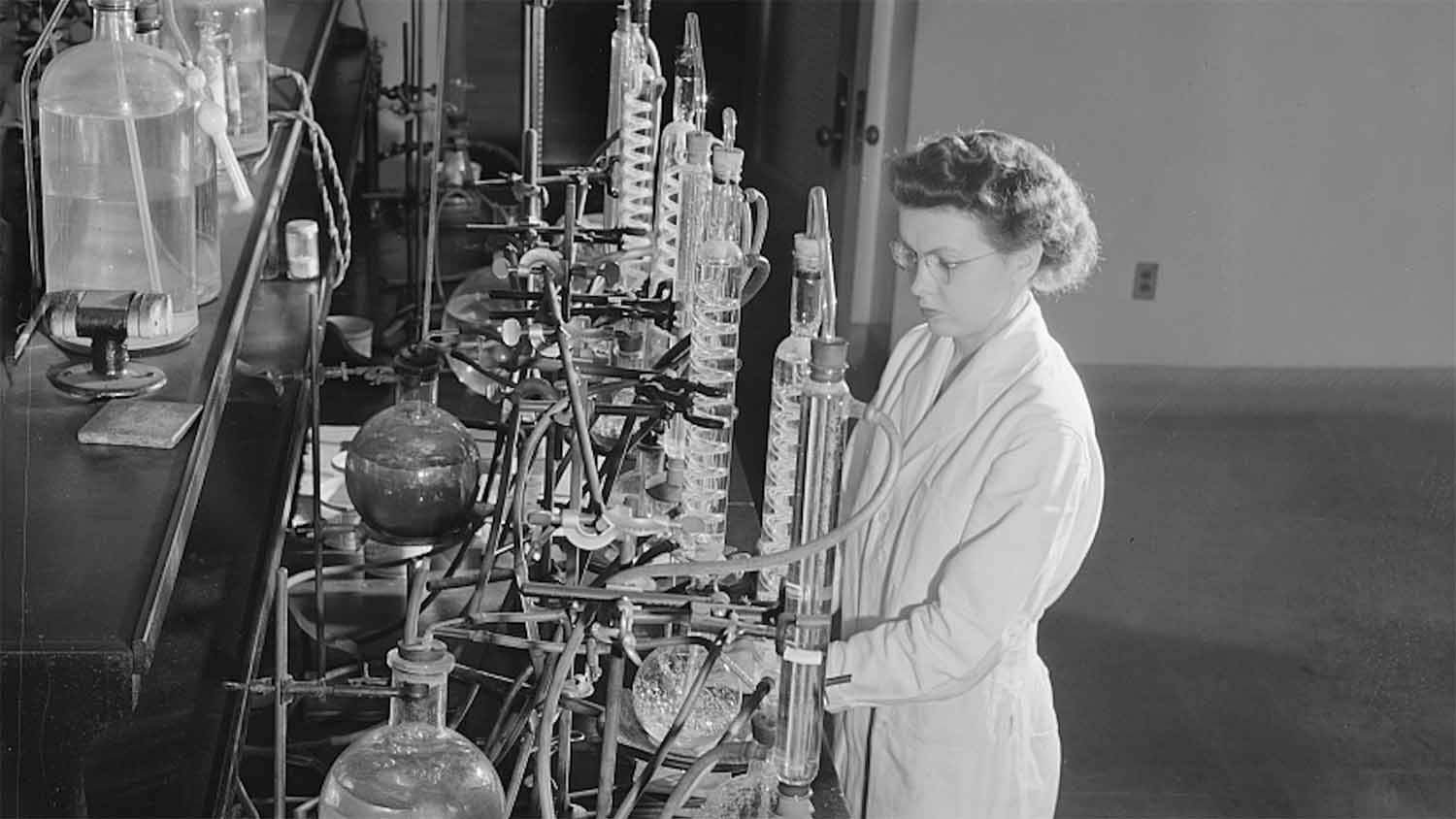 Jeanne Dougherty, a graduate student in bacteriology at Iowa State College's Dairy Industry Department, conducting experiments on the effect of acids in the laboratory, Ames, Iowa, May 1942, photographed by Jack Delano for the U.S. Office of War Information.