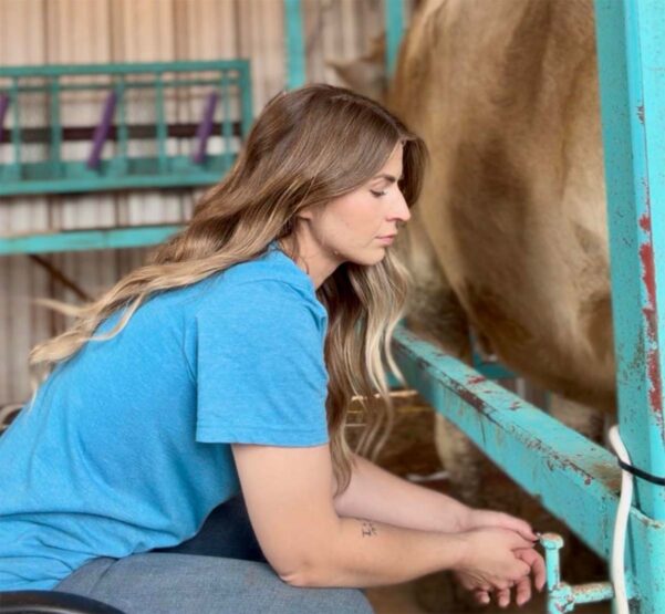 Jacy Vaughn at the milking stand at Like Wildflowers Homestead in Lamesa, Texas