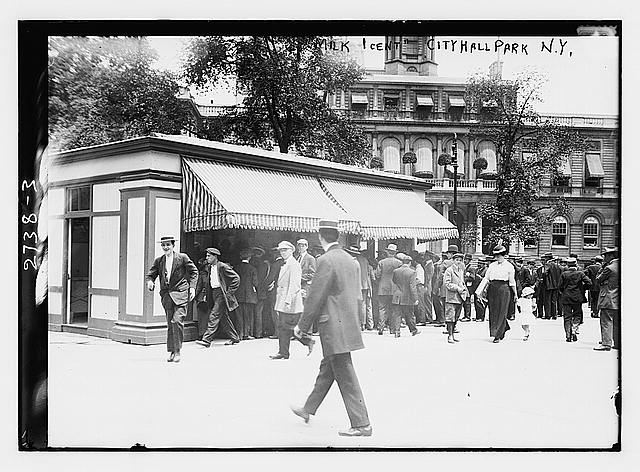 Crowd gathered at a one-cent milk depot in City Hall Park, New York City, early 1900s