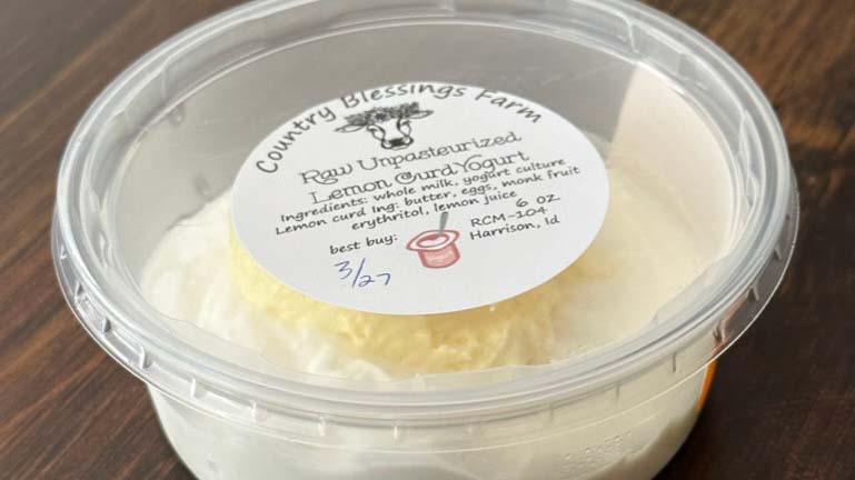 Container of raw unpasteurized lemon curd yogurt from a small dairy farm, illustrating fermented raw dairy